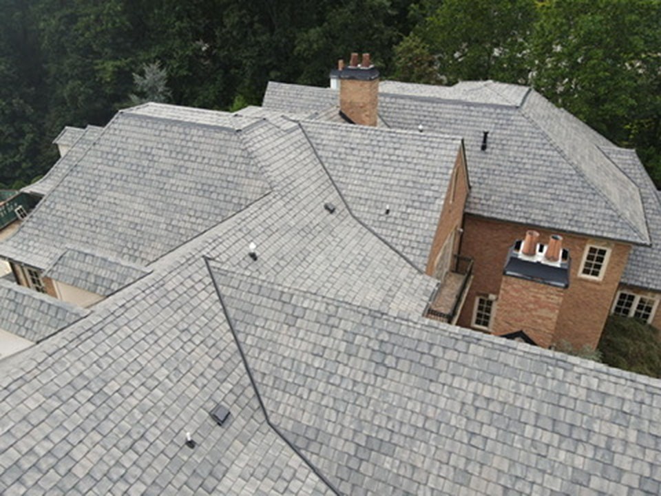 Brava composite slate on a brick estate home - the look of natural slate at a fraction of the weight.