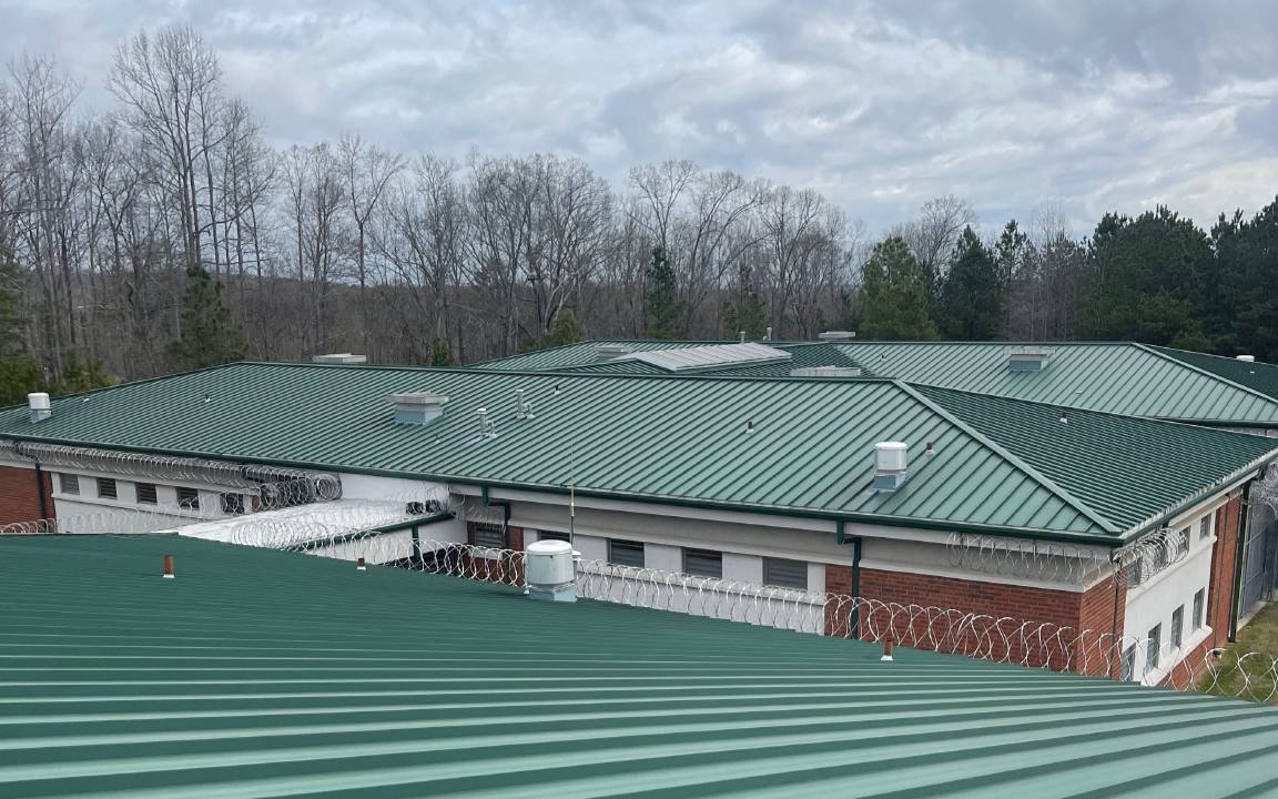 Green standing seam metal roof on a commercial building.