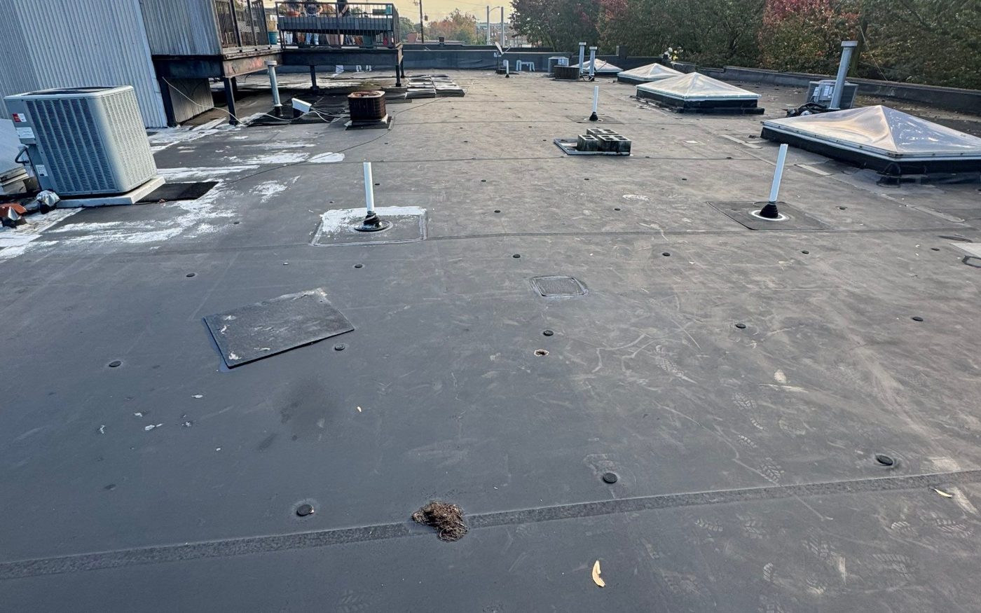 An EPDM rubber roof on an Atlanta loft building. Pipe boots, patches, curbs and seams are where these roofs fail first.