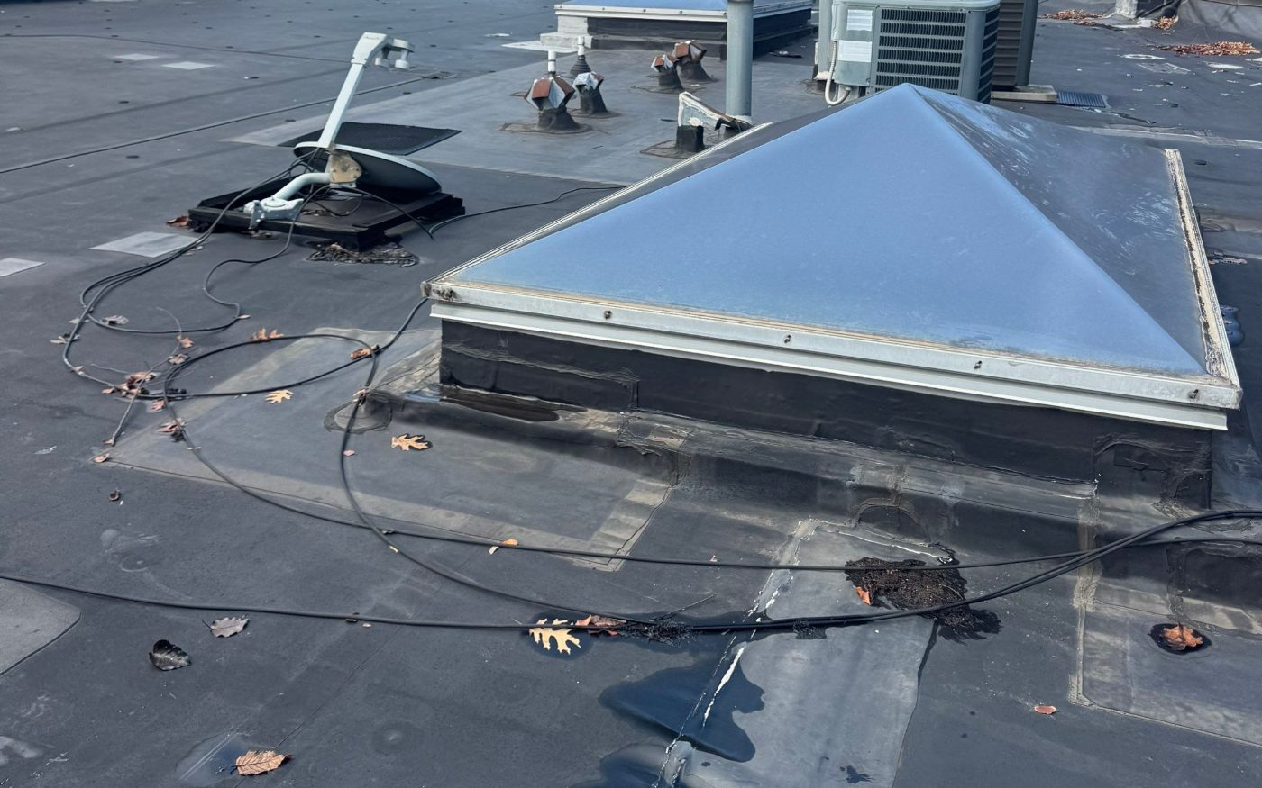 A pyramid skylight on the same EPDM roof. The flashing around the curb is a common leak point.