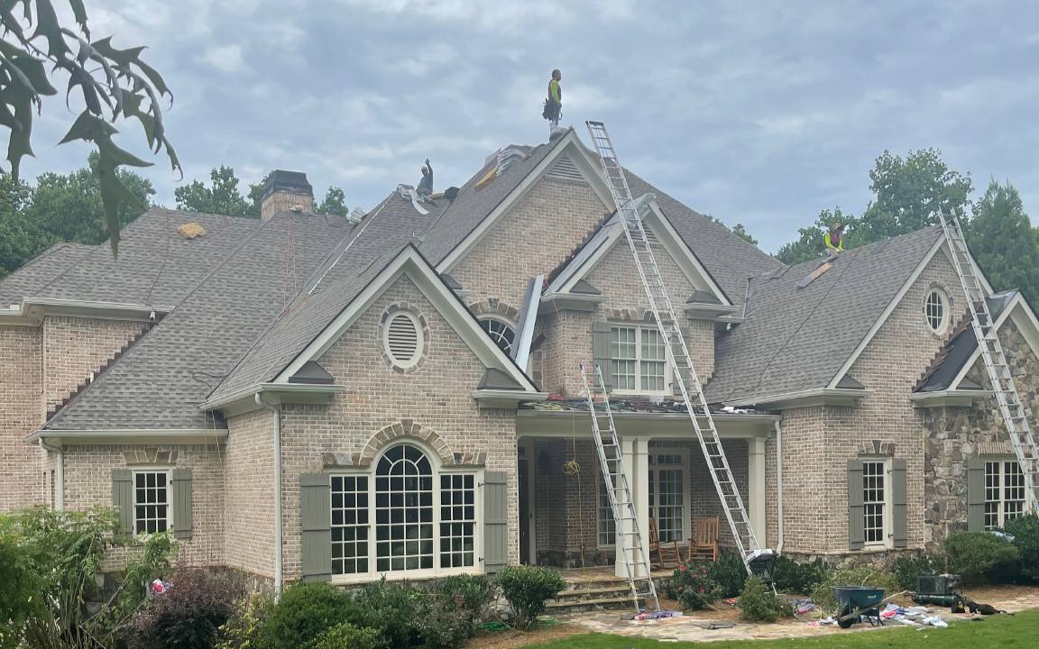 A new architectural shingle roof going on a two-story brick home.