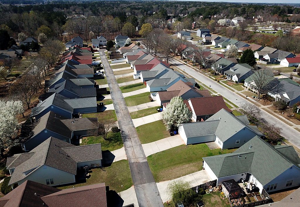 Aerial view of a metro Atlanta neighborhood with rows of shingle roofs