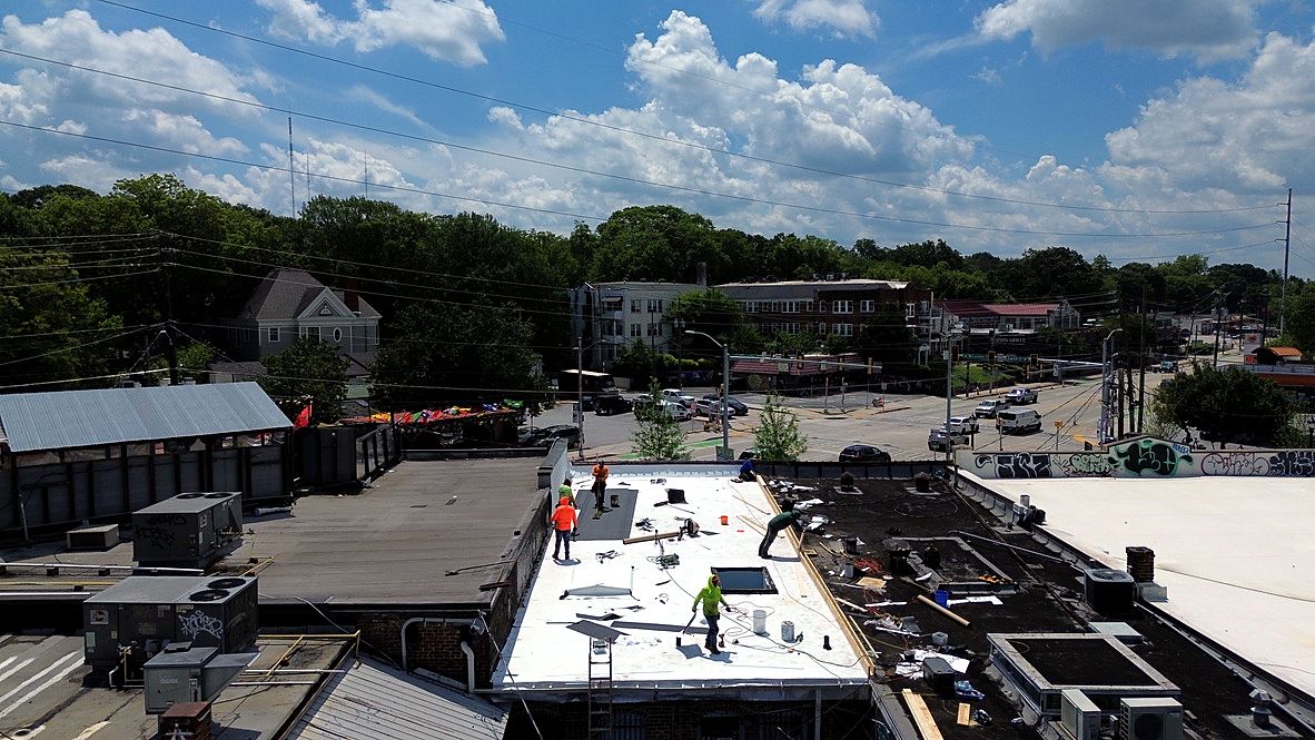 Our crew installing a new membrane roof on a commercial building