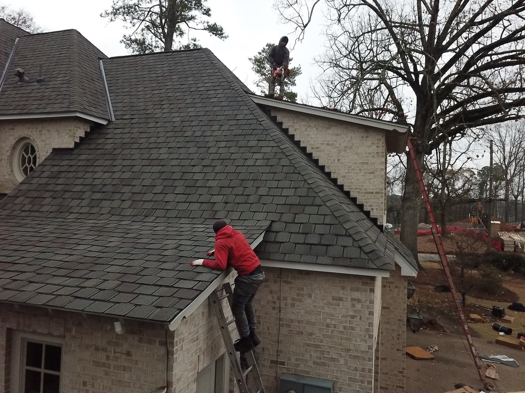 Our crew finishing the eaves and hip lines on a designer shingle replacement.