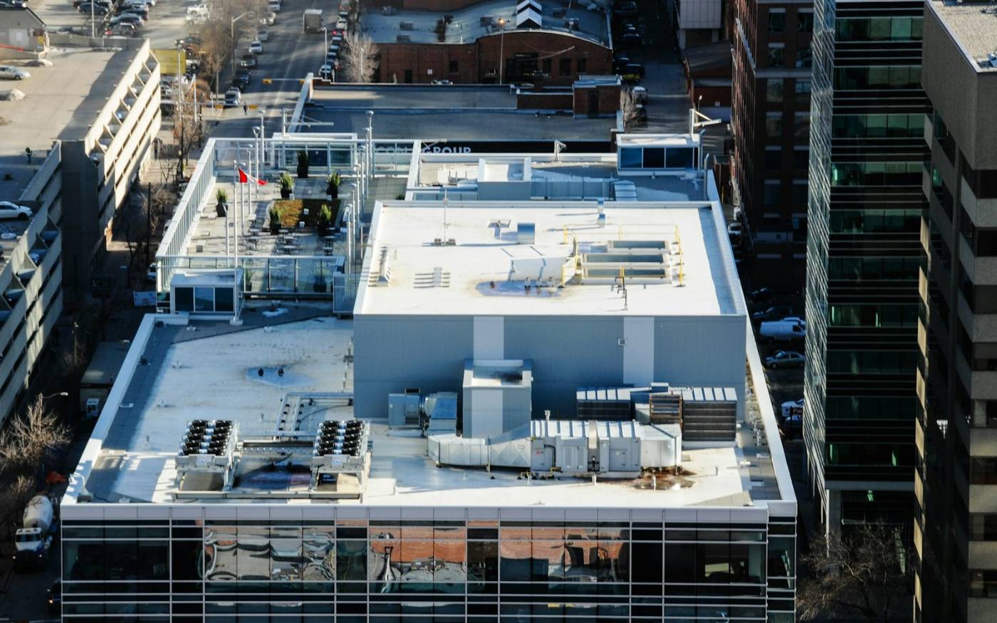 Bright white commercial roof surface with rooftop HVAC units seen from above