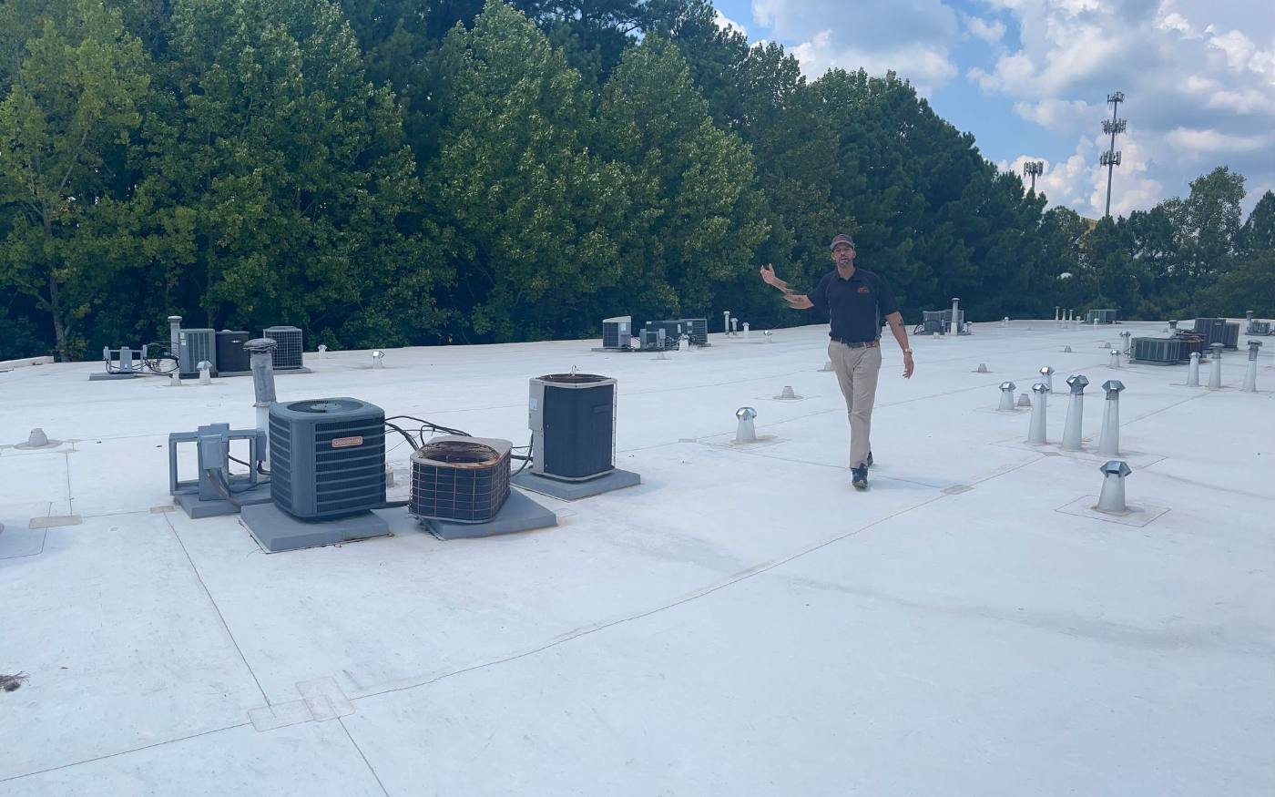 Finished white single-ply flat roof with rooftop HVAC units flashed in