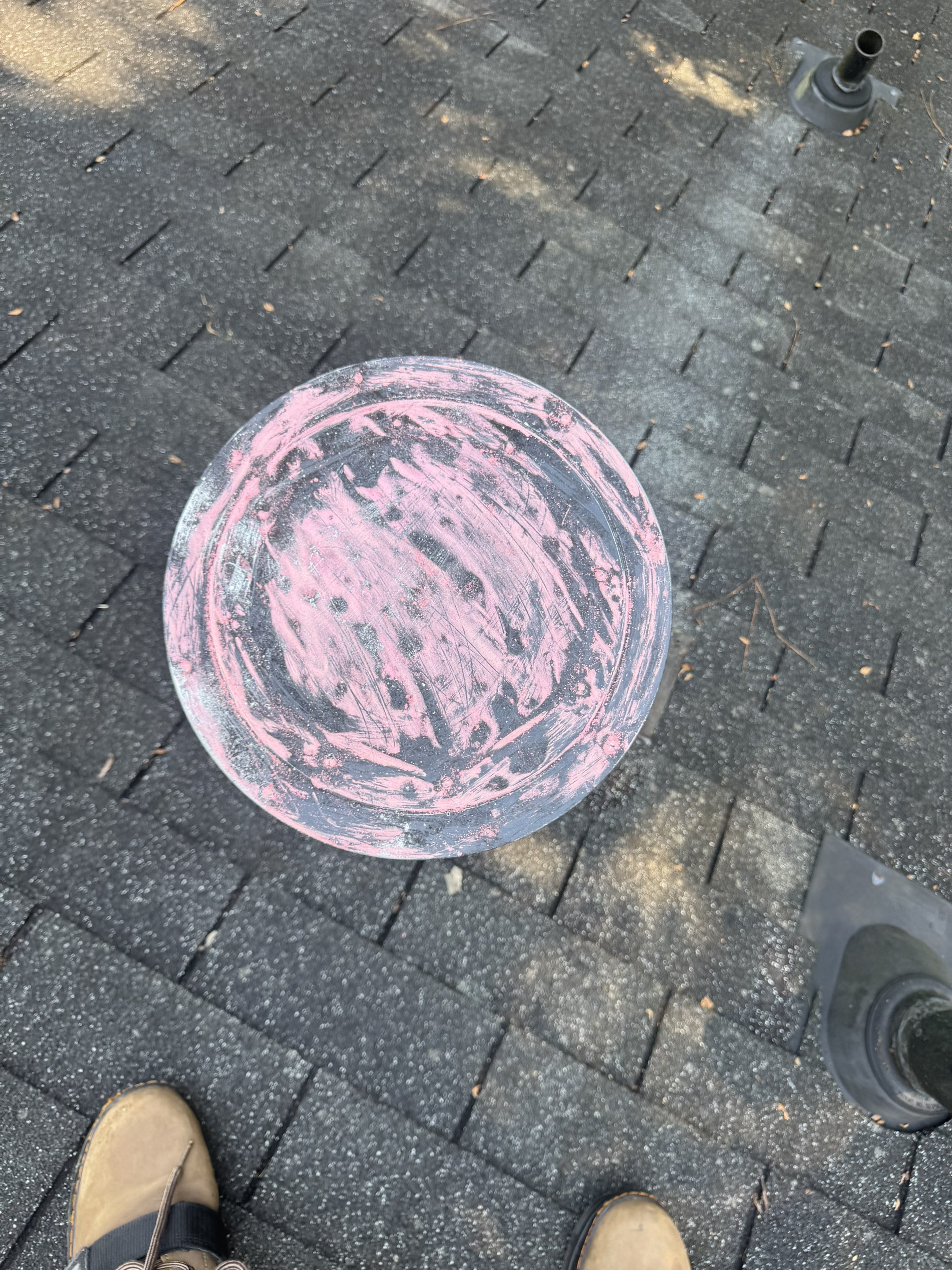 Close-up of roof vent boot with pink chalk damage markings during hail damage inspection