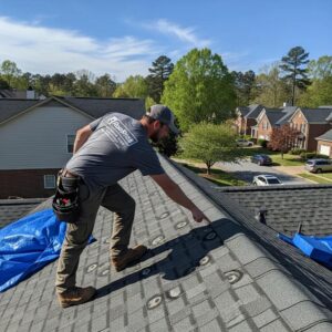Roswell roofing contractor inspecting hail damage on a residential roof in Roswell, GA